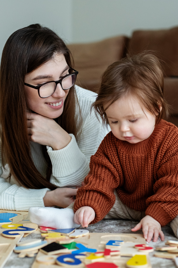 Caregiver playing with little girl